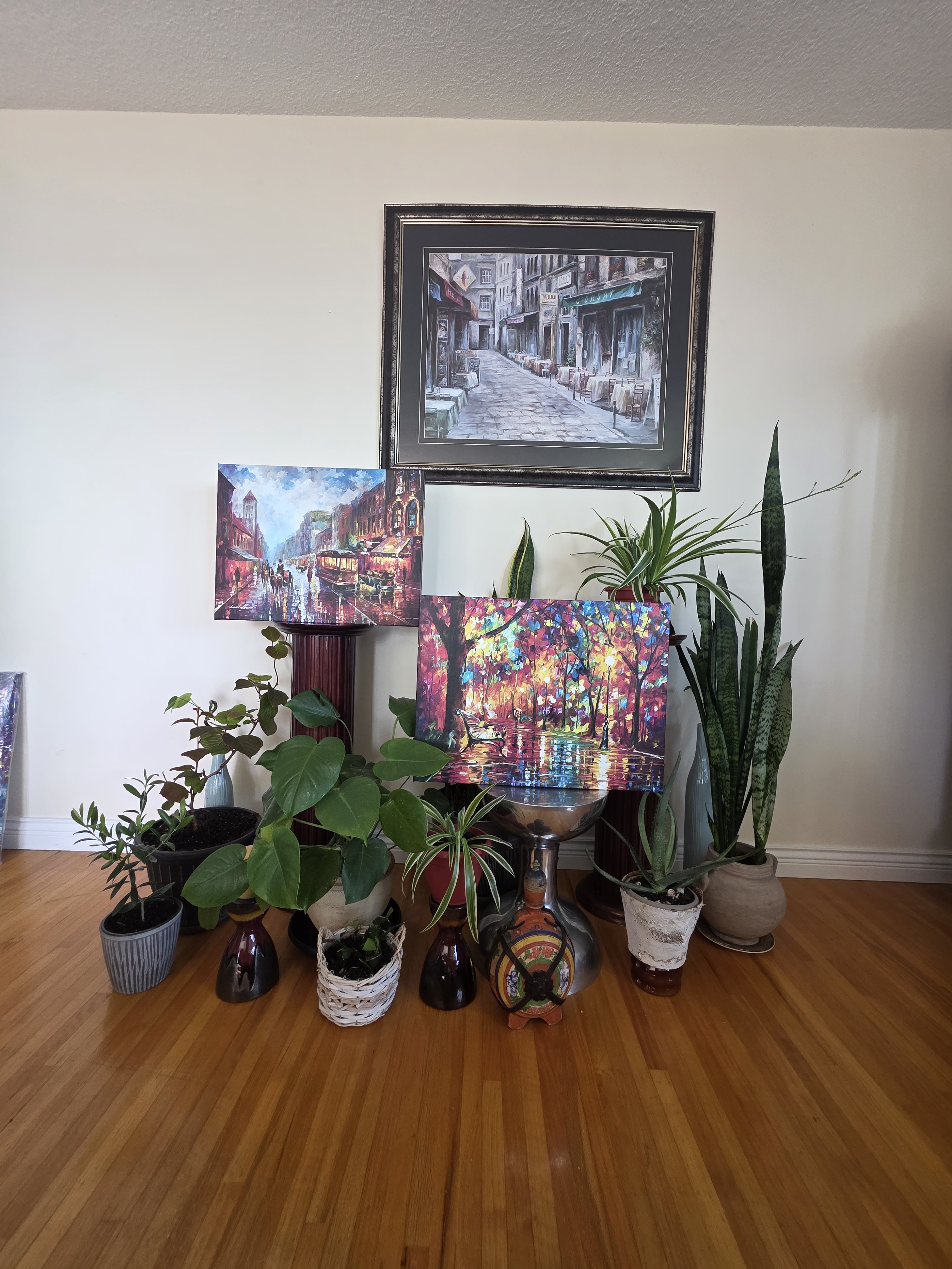 Curated gallery wall with framed art and living plants